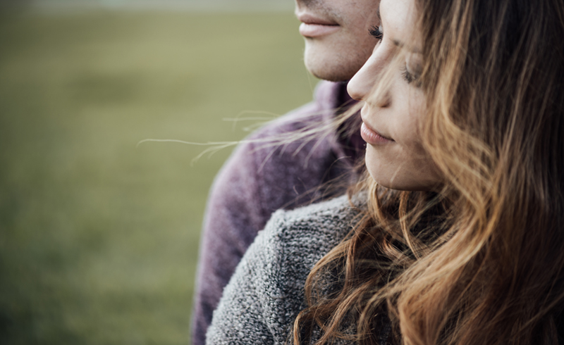 young couple looking off to the side
